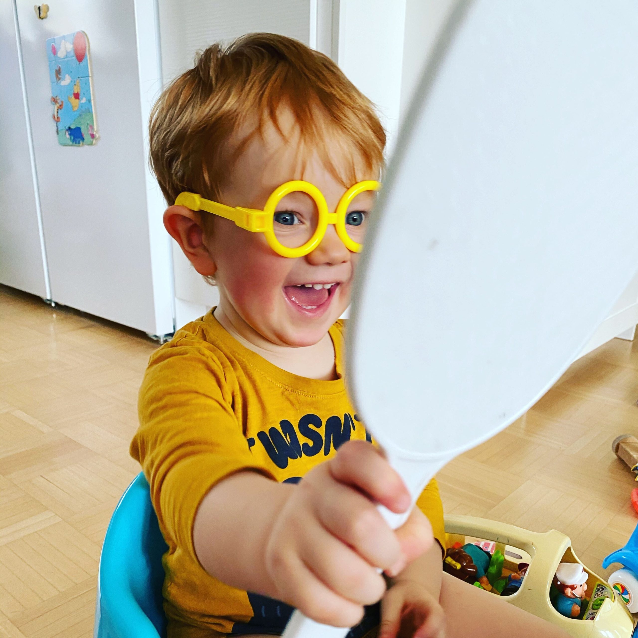 Kid smiling at a mirror