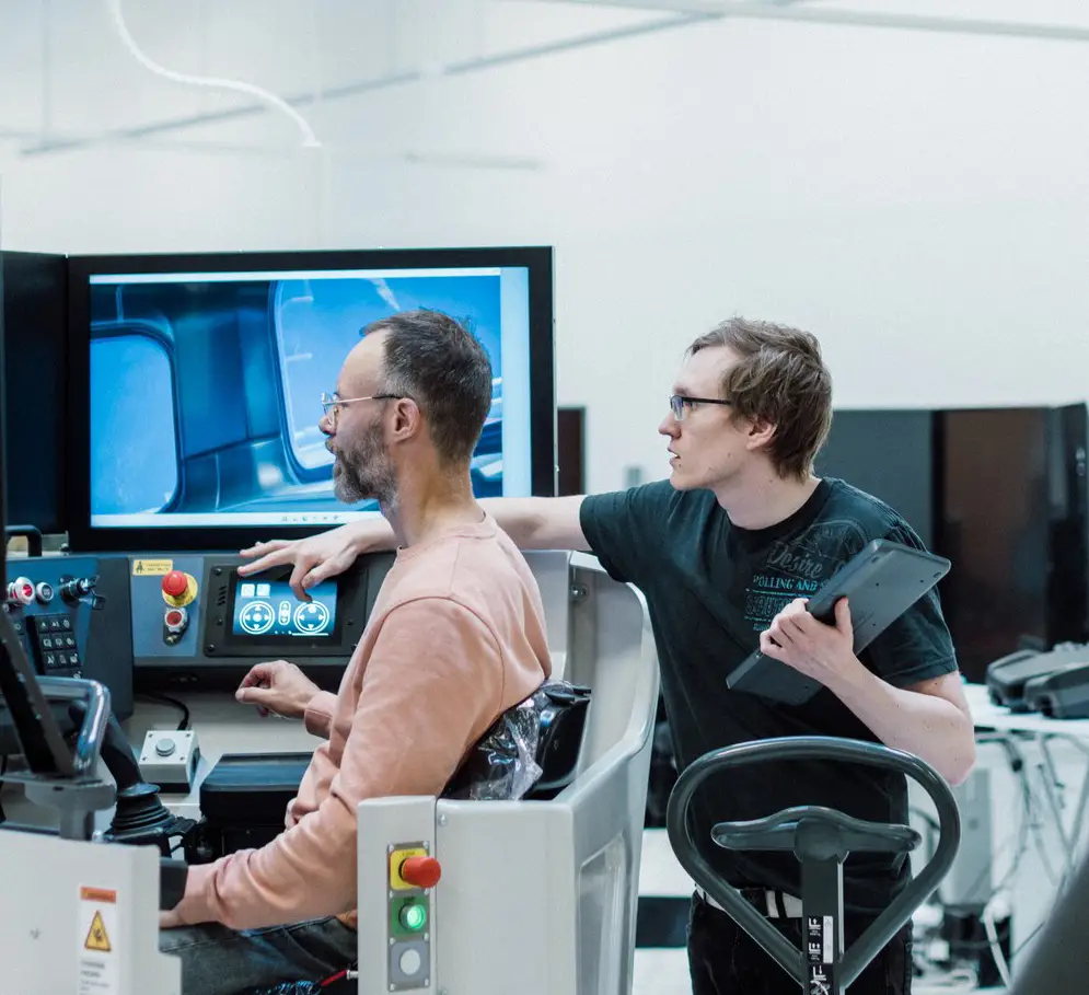 two men configuring a simulator