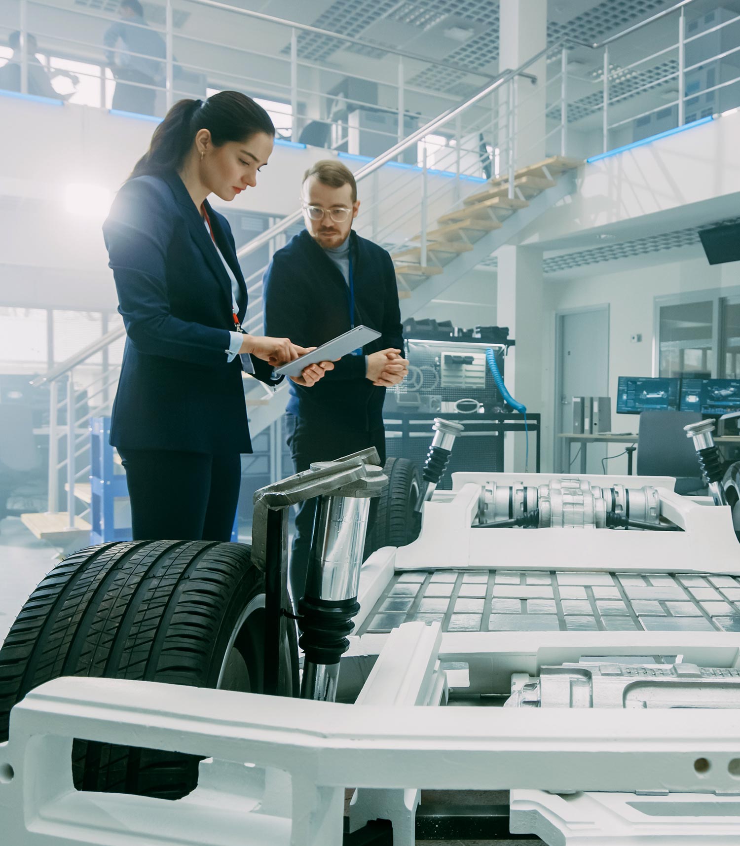 Woman and man standing by electric car prototype