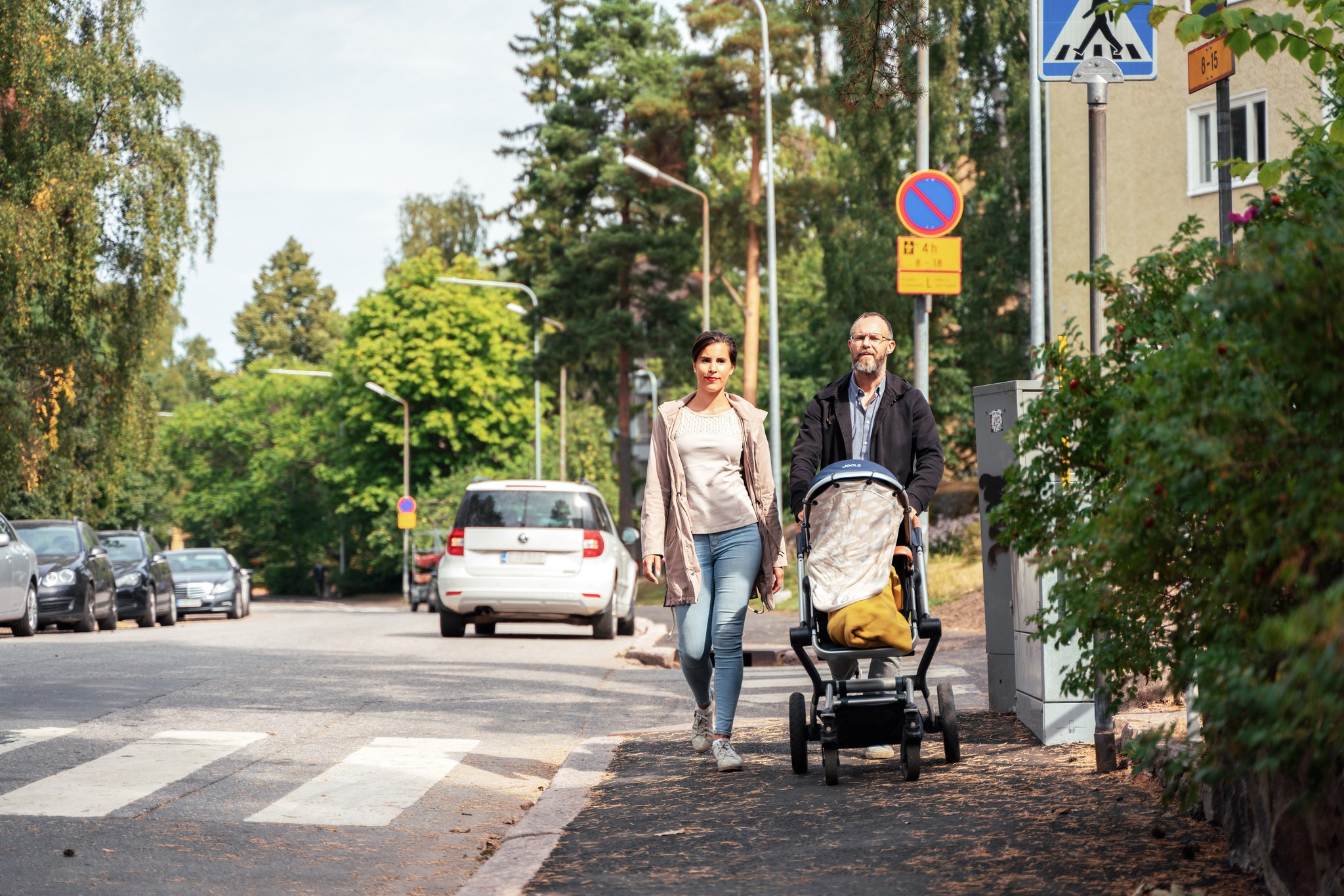 A family on a walk on sunny street