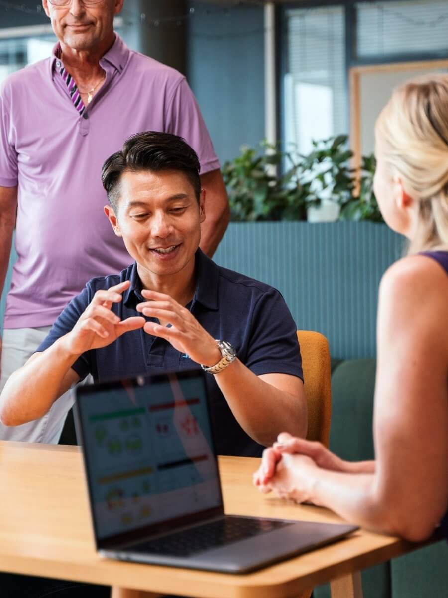 Three people discussing over table