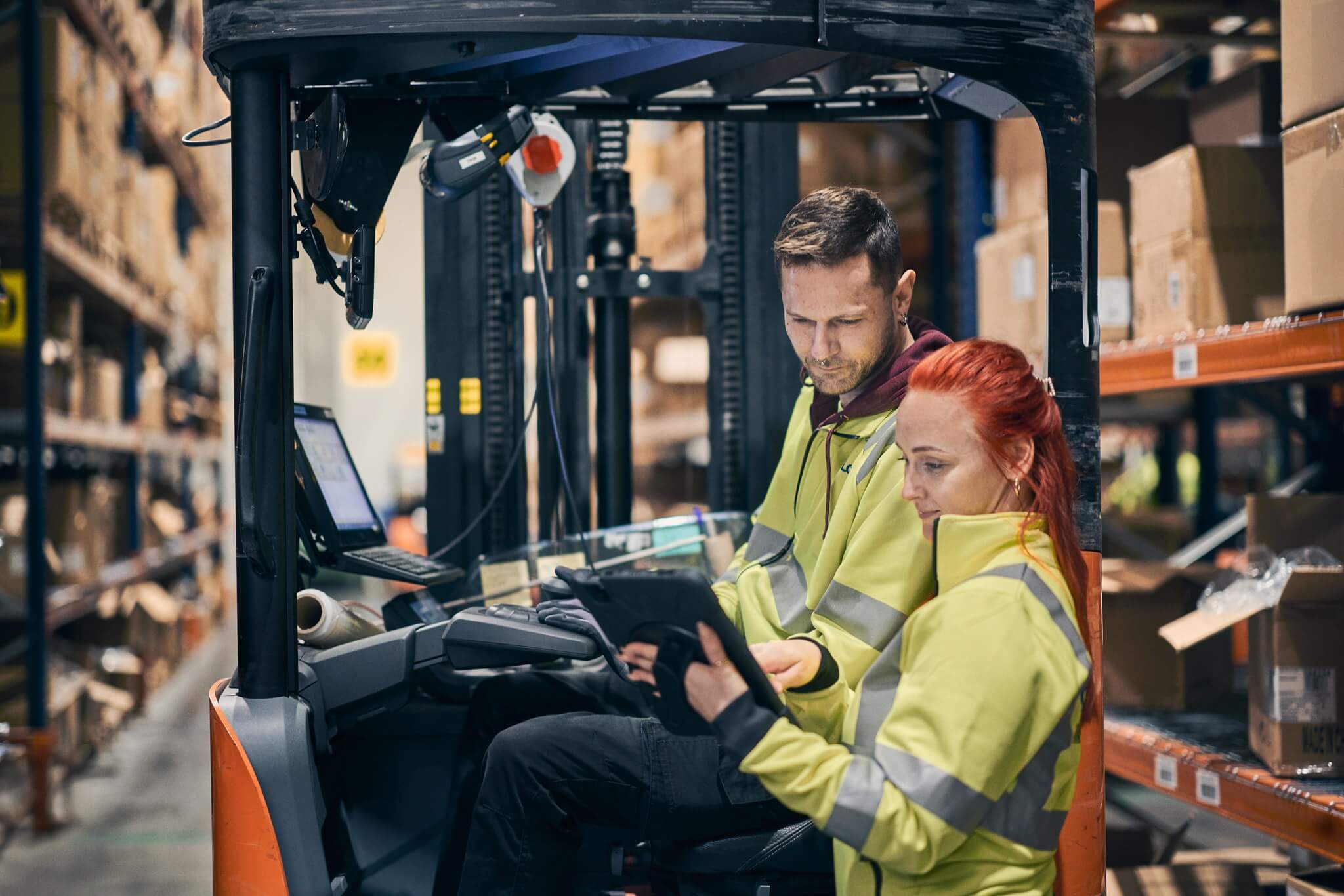 two people looking at a tablet computer in an industrial set up