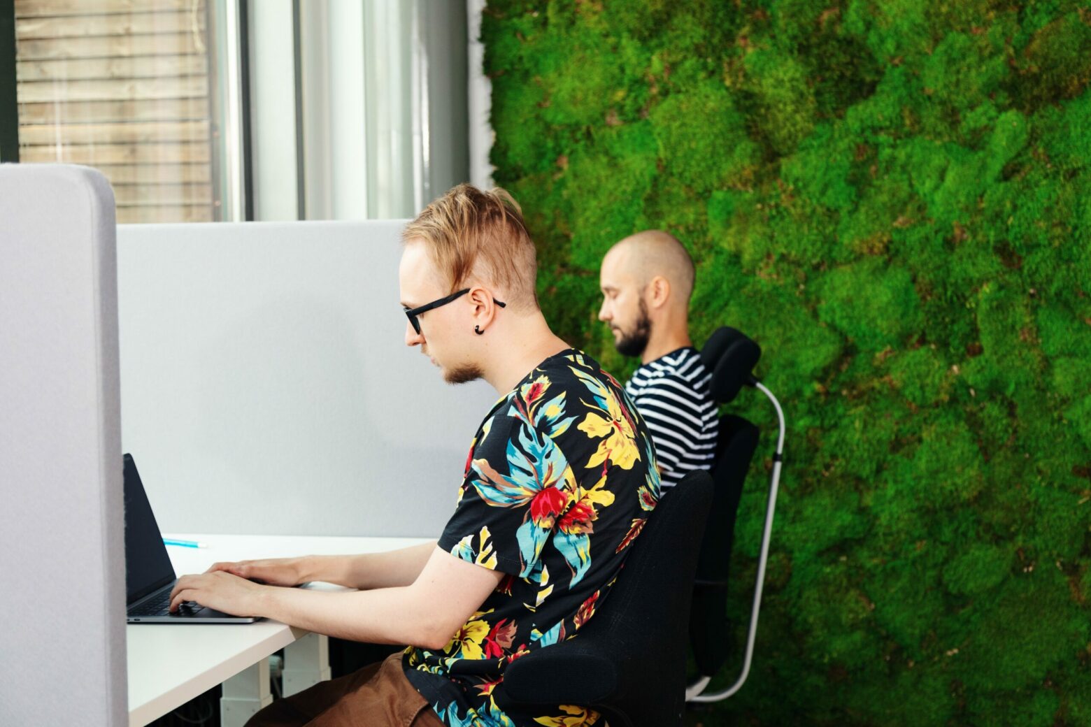 two men sitting by their desks working