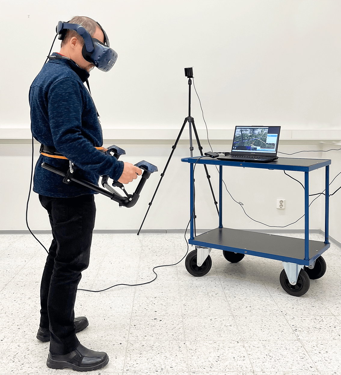 Picture of a person operating the VR based brushcutter simulator.